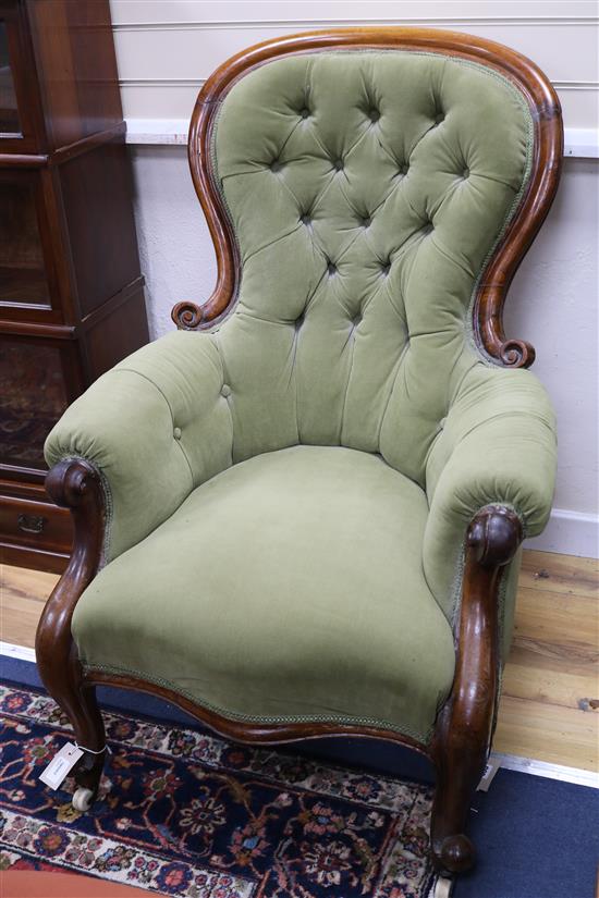 A Victorian carved walnut armchair on cabriole legs